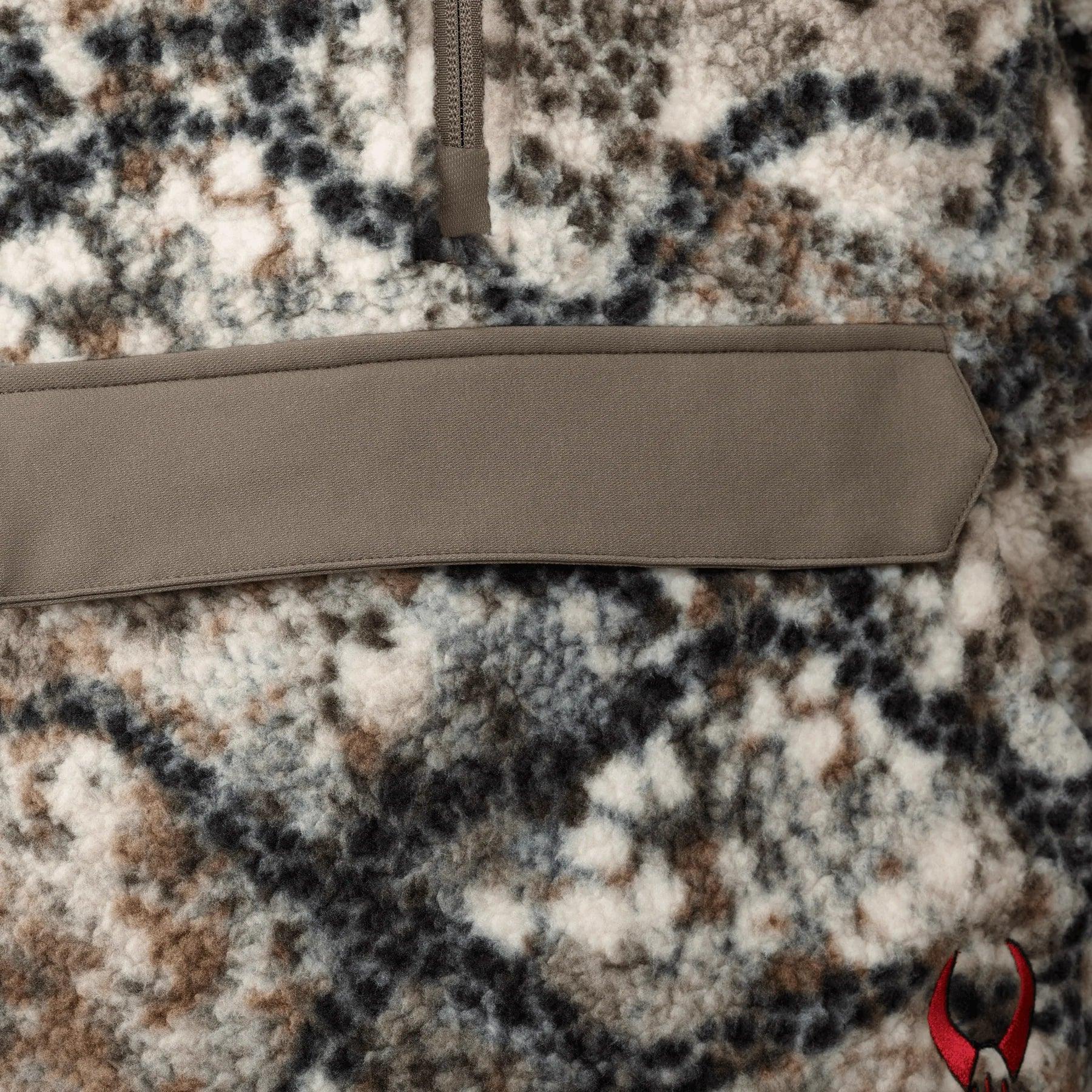 Close-up of Badlands Silens Fleece Hoodie in camo pattern with front pocket and red logo
