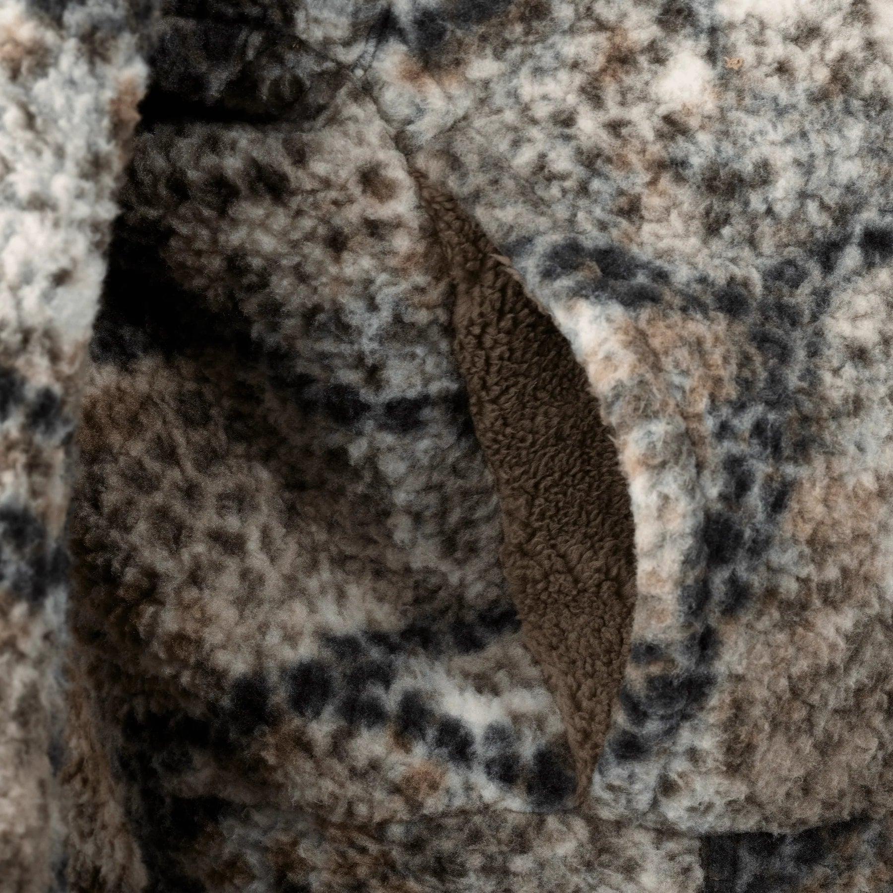 Close-up of Badlands Silens jacket camo fleece fabric and pocket texture