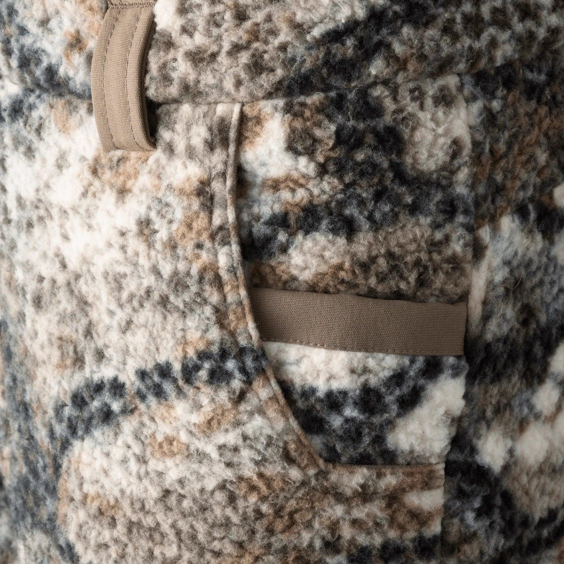 Close-up of Badlands Silens Pant pocket with brown, gray, and white camouflage fleece fabric