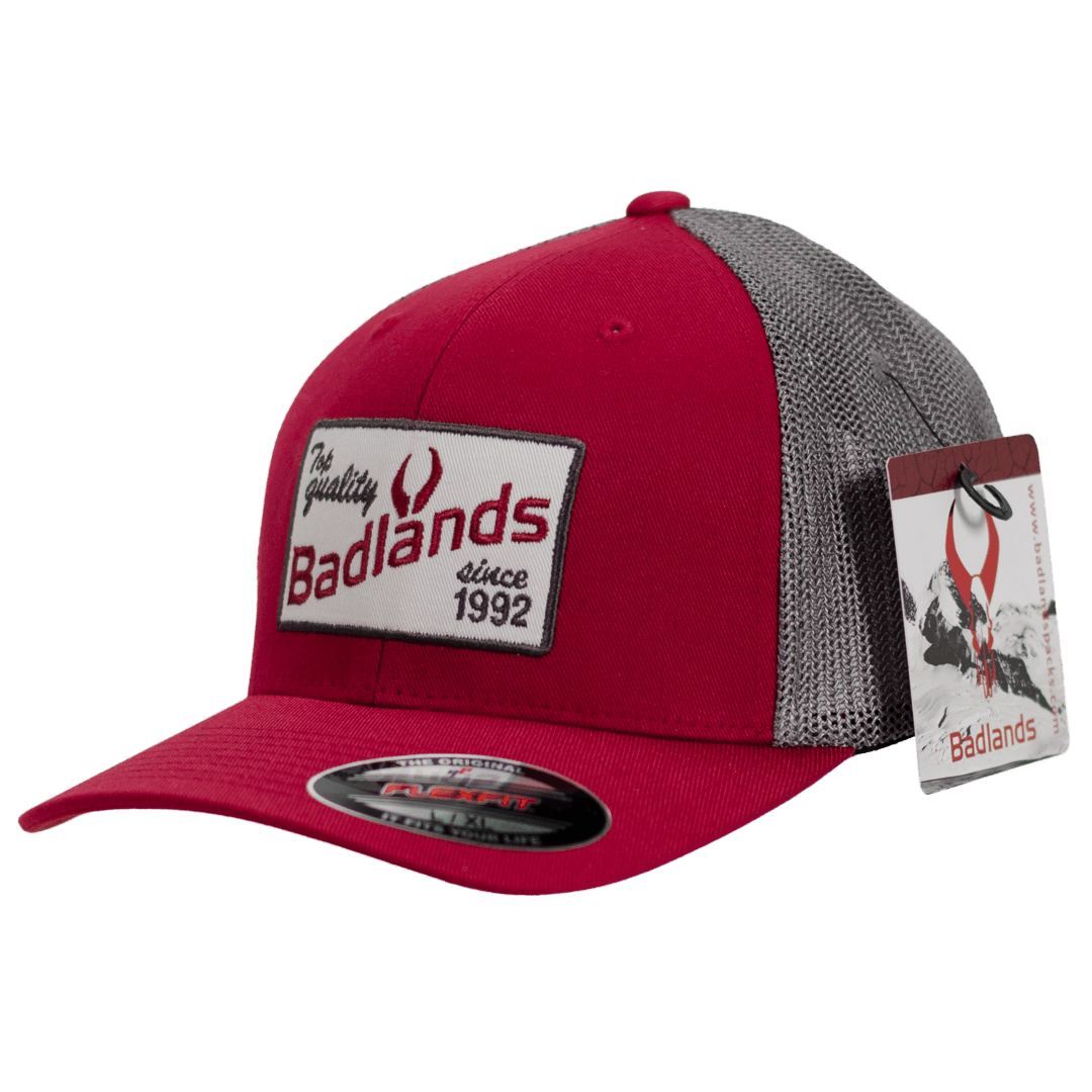 Red and gray Badlands trucker hat with mesh back and logo patch, outdoor apparel