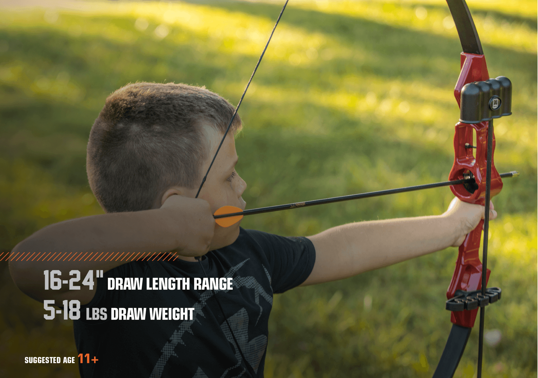 Youth aiming Bear Archery Flash traditional recurve bow outdoors with orange arrow