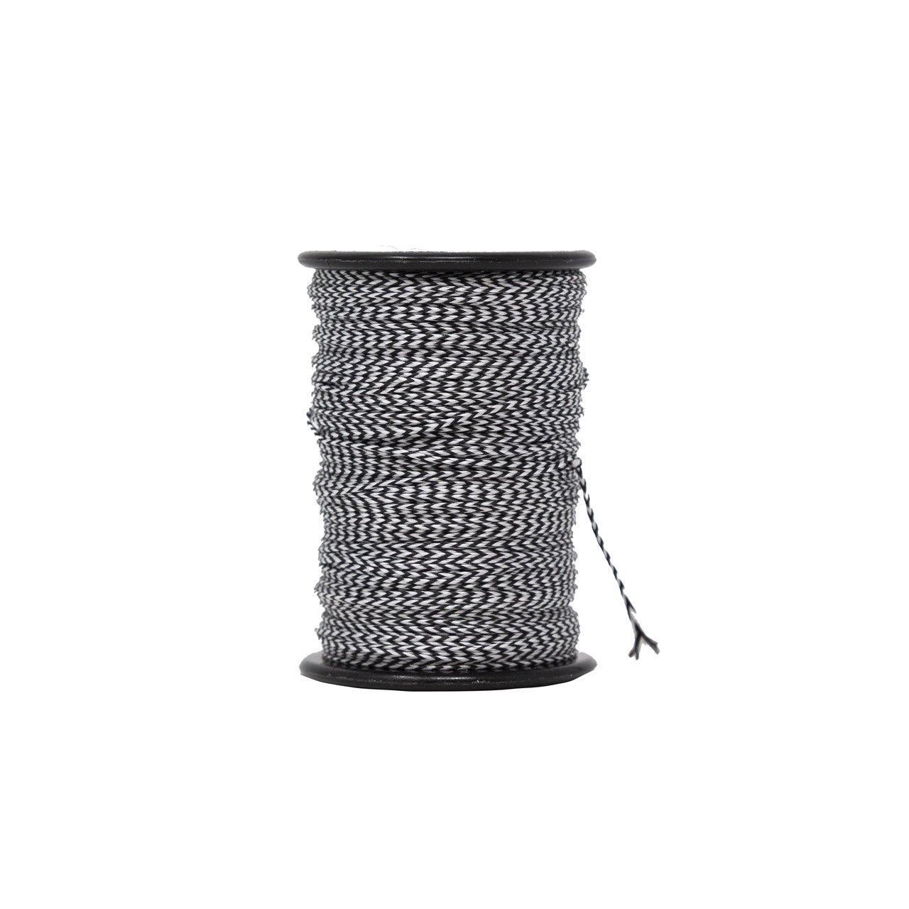 Black and white braided archery serving thread spool on white background