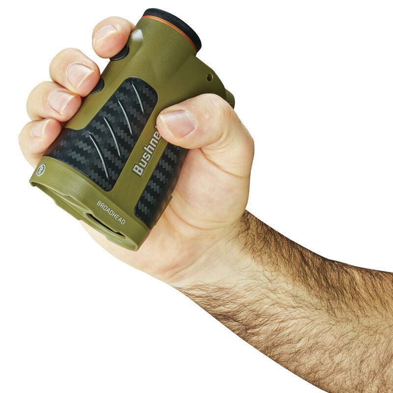 Hand holding Bushnell Broadhead laser rangefinder with green and black grip