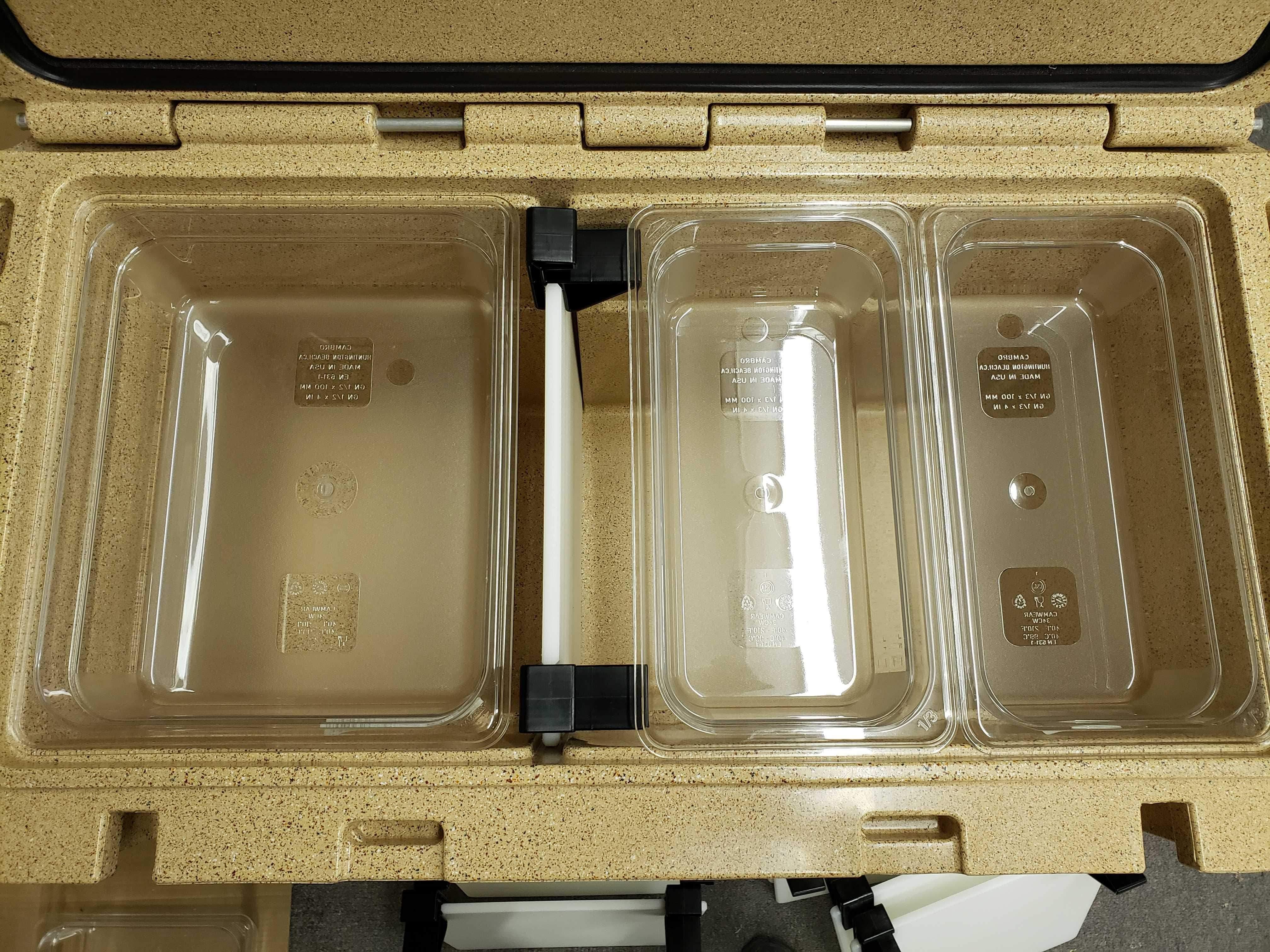 Canyon Coolers catering pan with three clear plastic food trays inside tan insulated cooler