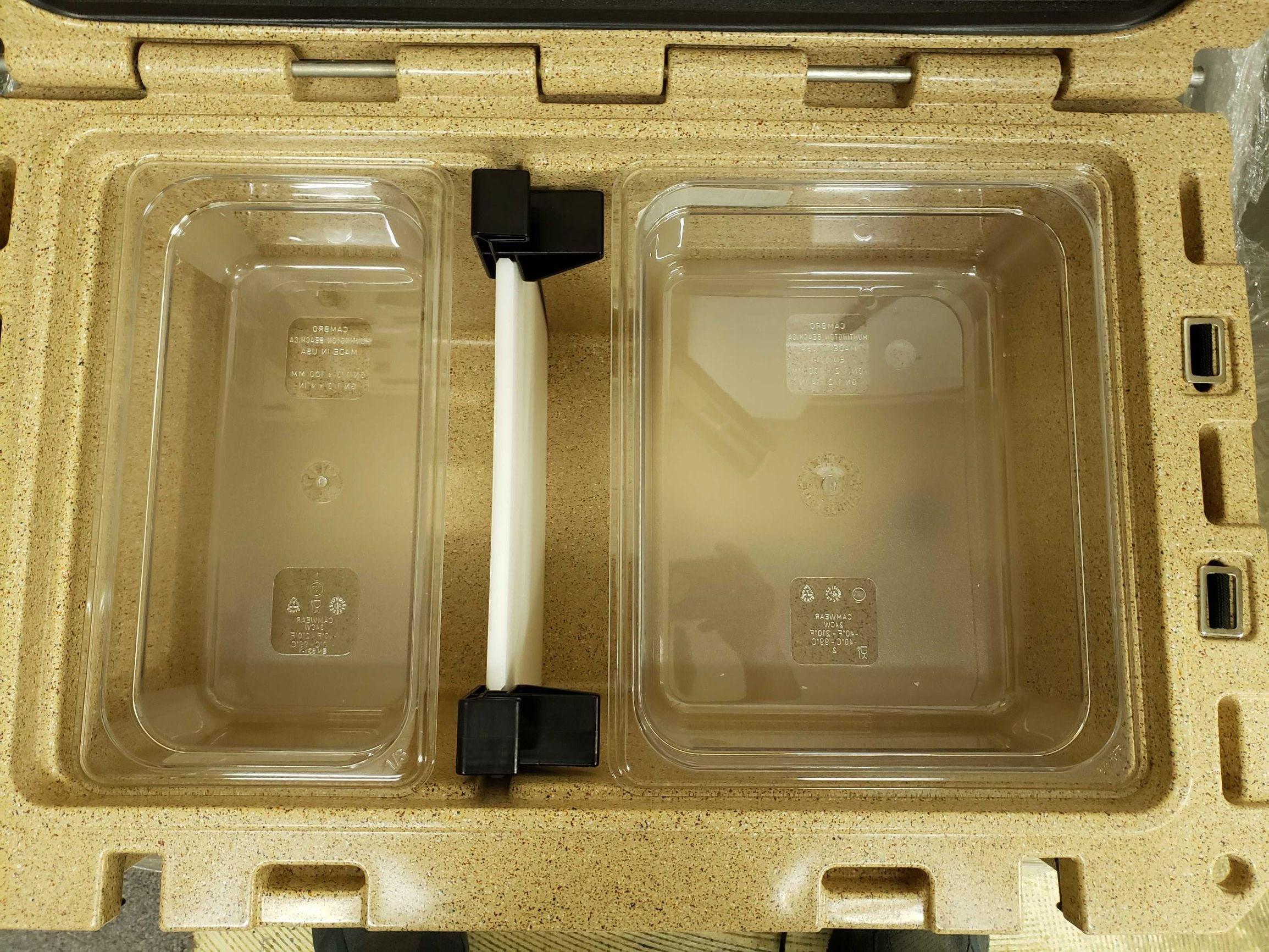 Canyon Coolers Pro 45 tan catering cooler with two clear food pans and white handle