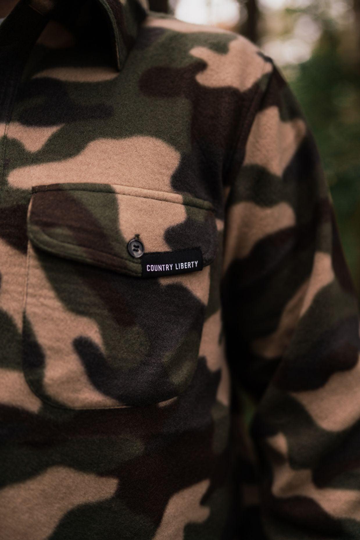 Close-up of Country Liberty unisex camo fleece shirt with buttoned chest pocket outdoors