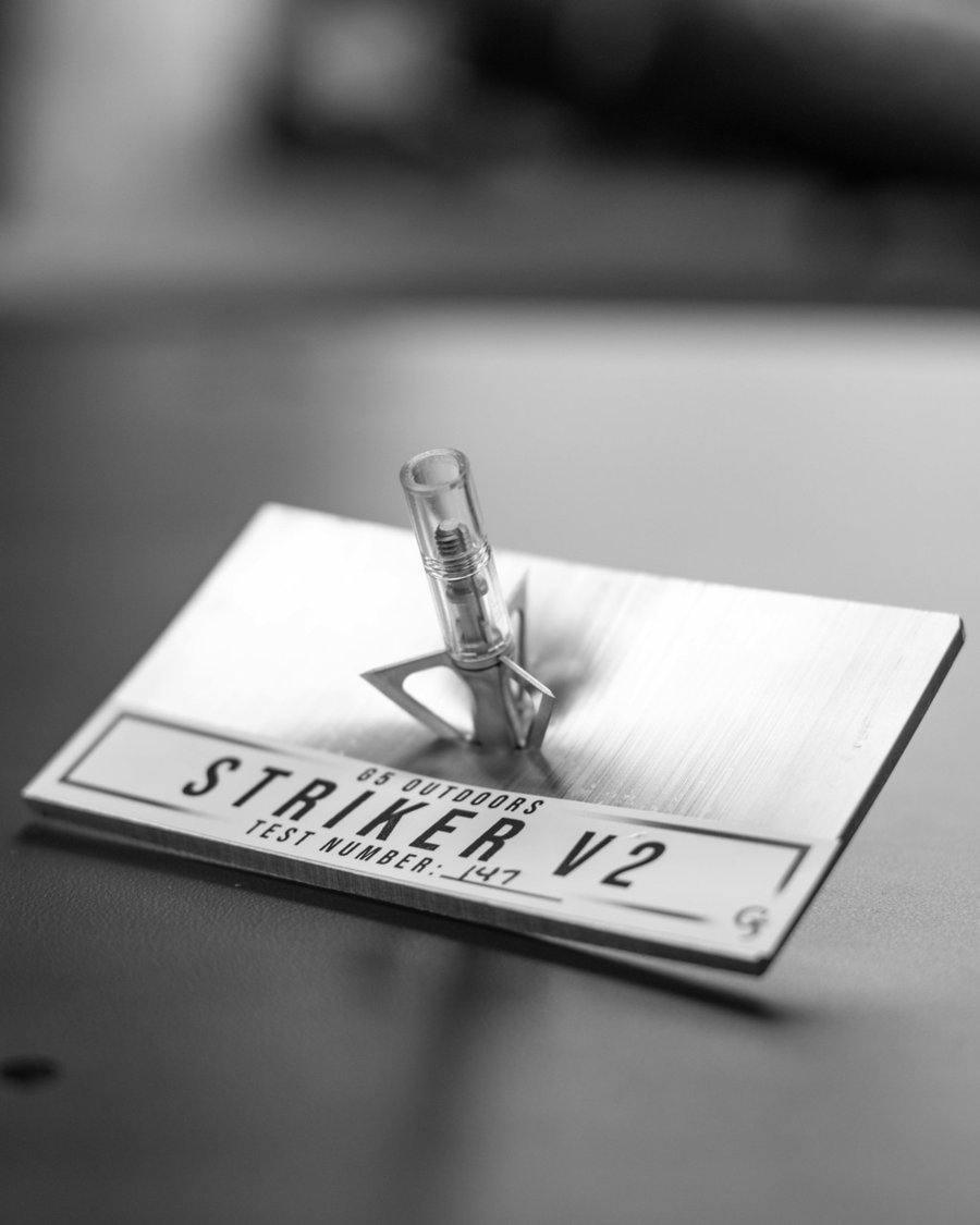 G5 Outdoors Striker V2 broadhead on metal test block, archery equipment close-up