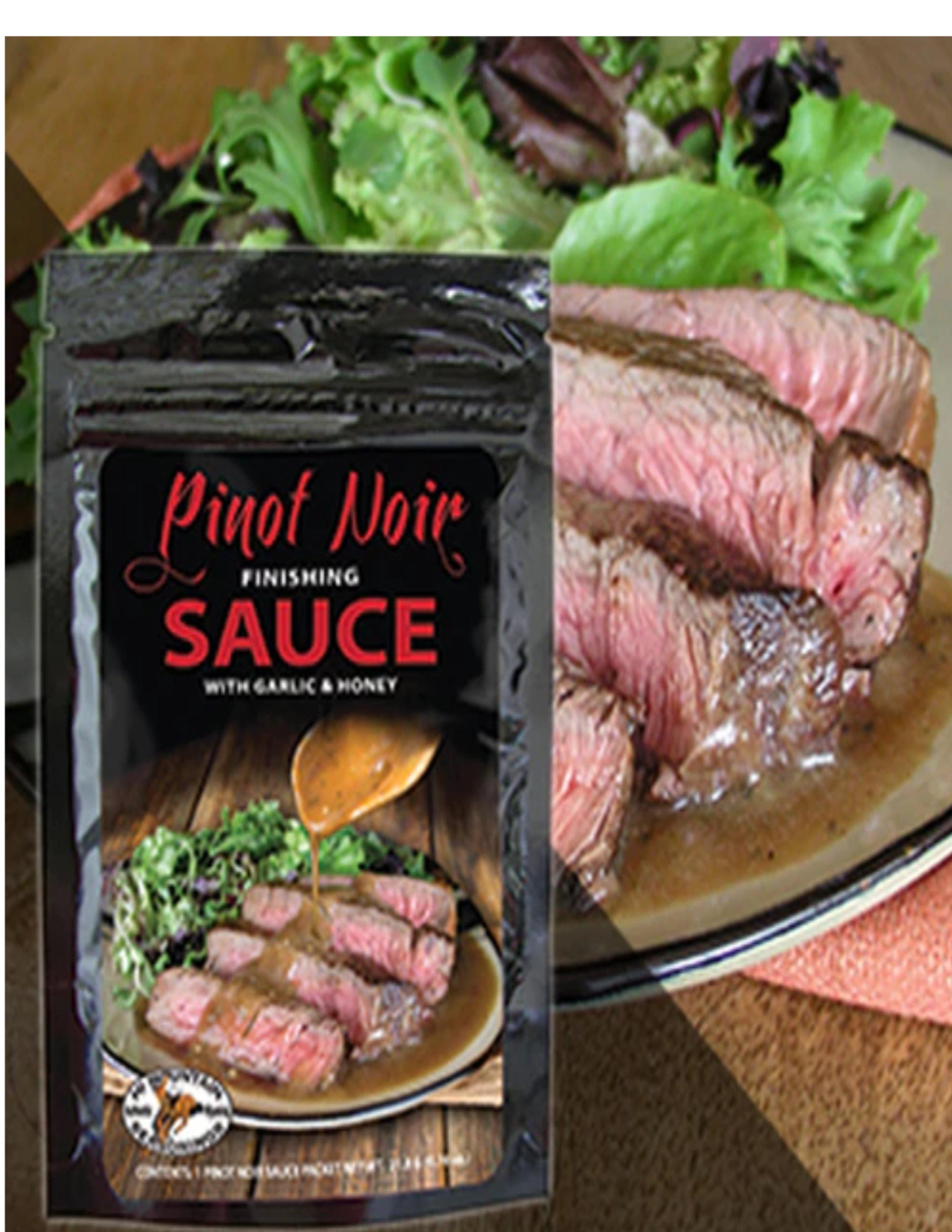 Pinot Noir finishing sauce packet with garlic and honey beside sliced steak and salad plate