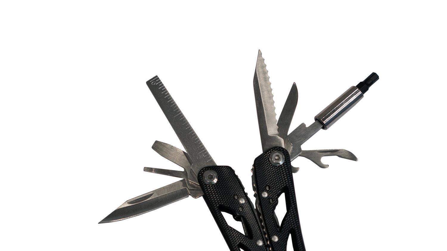 Black multi-tool with knife, ruler, screwdriver, and other tools on white background