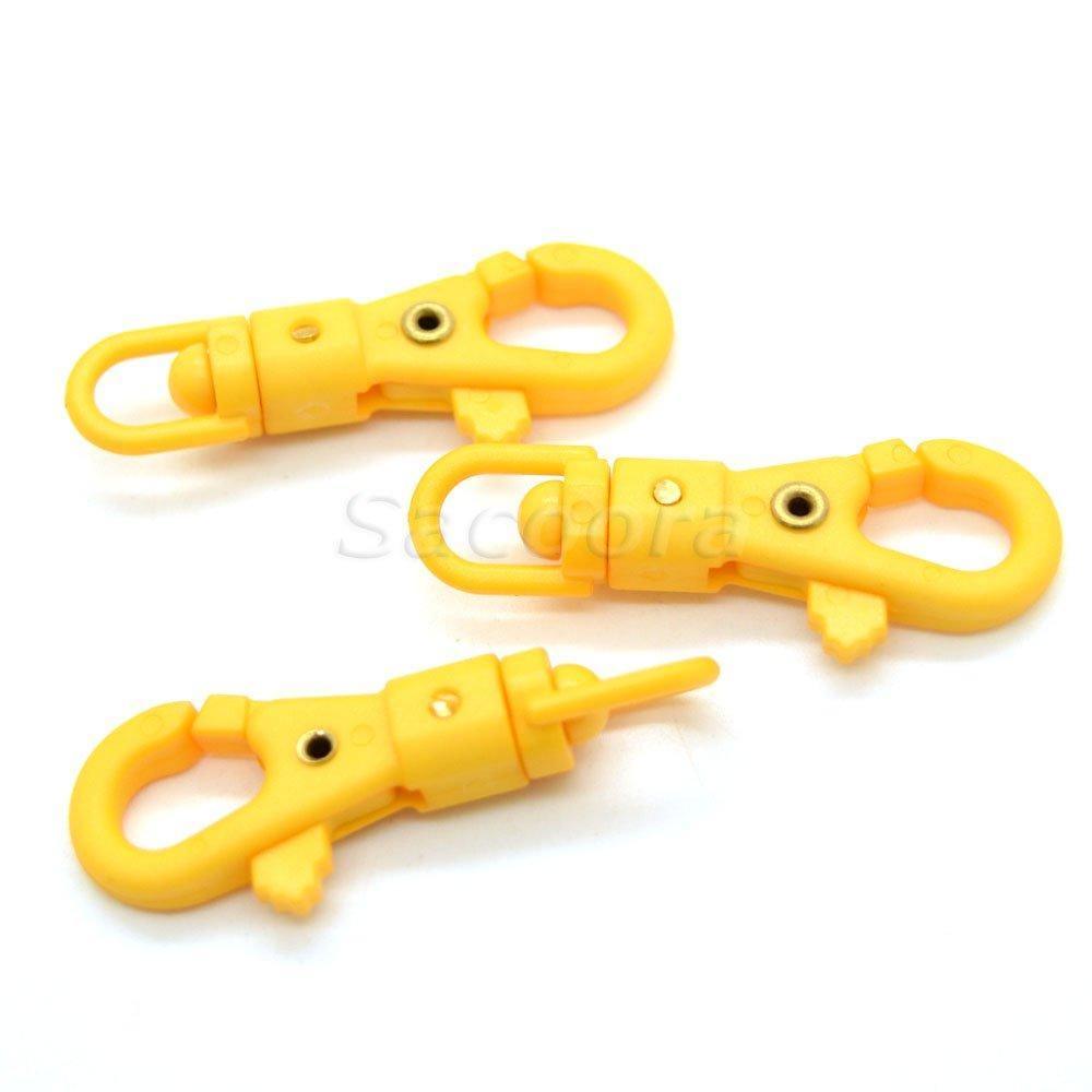 Yellow paracord plastic swivel snap hooks on white background, outdoor gear accessories
