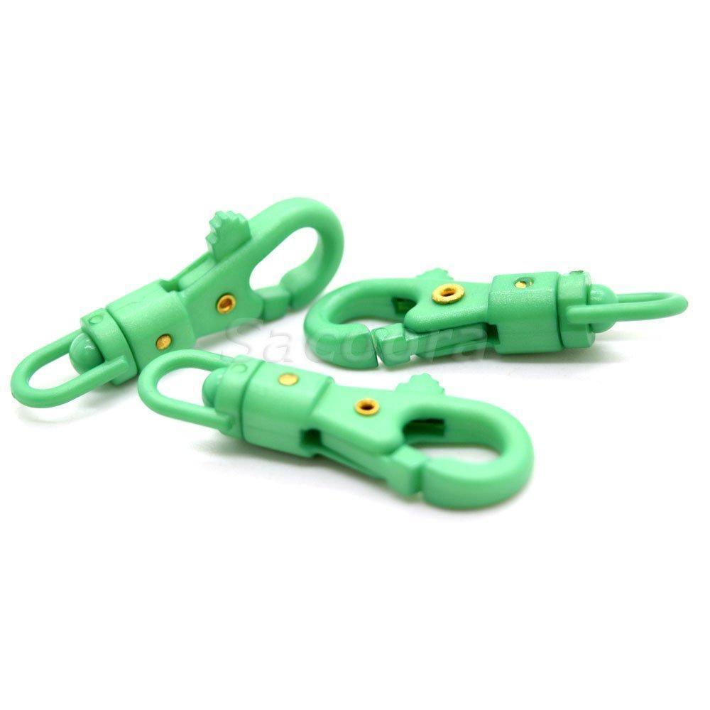 Green paracord plastic swivel snap hooks with gold rivets on white background