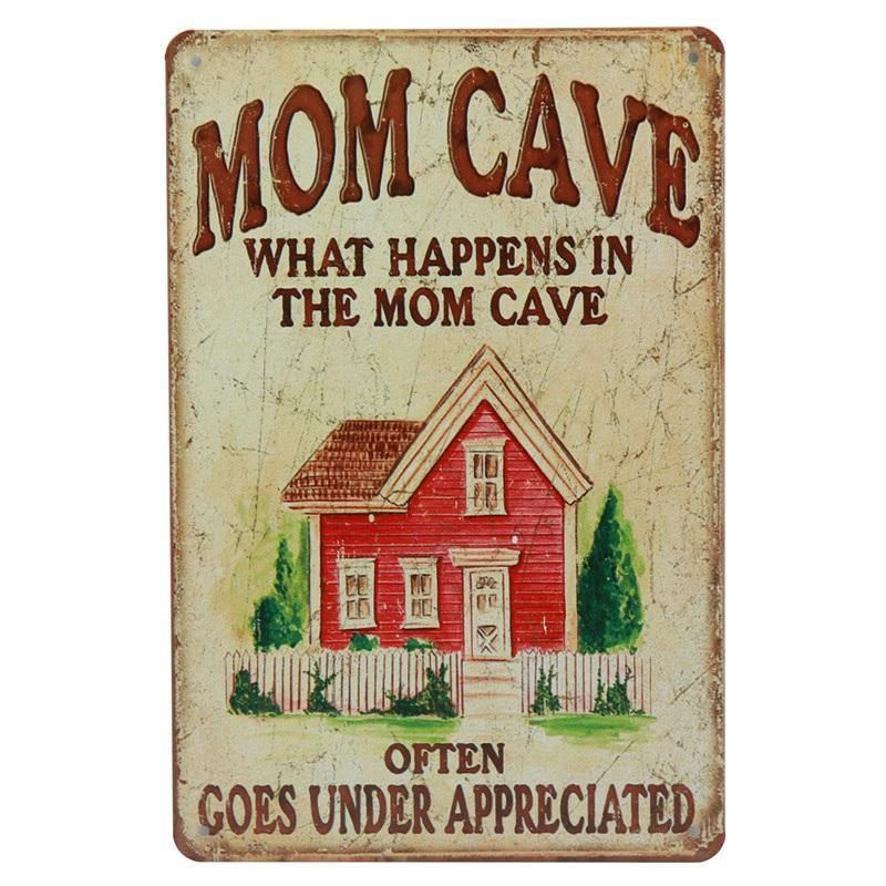 Vintage metal sign reading Mom Cave with red house illustration and humorous message.