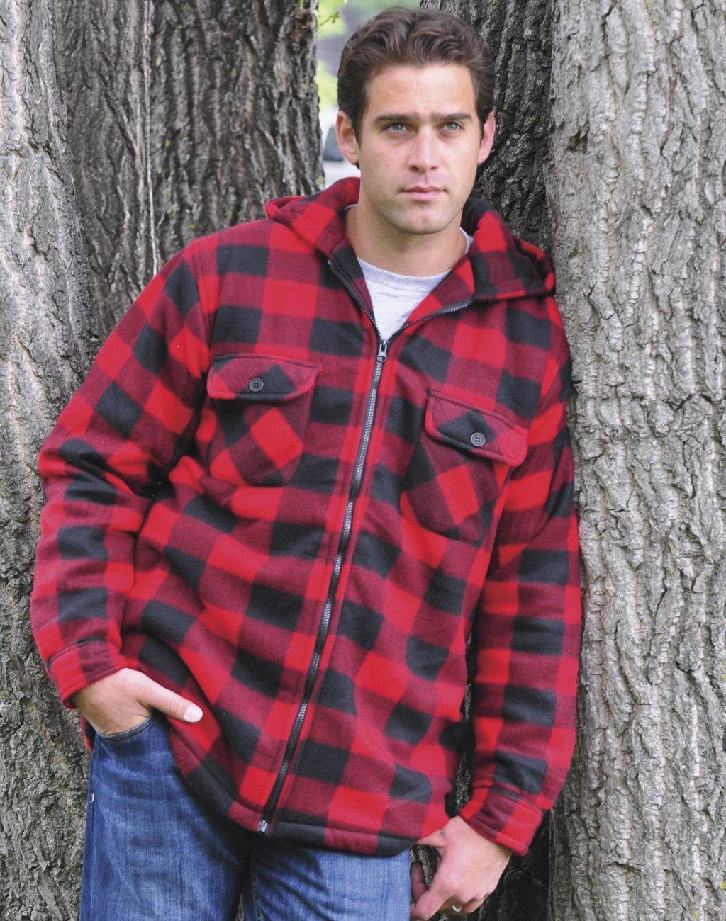 Man wearing red and black plaid fleece hooded jacket outdoors by tree trunks