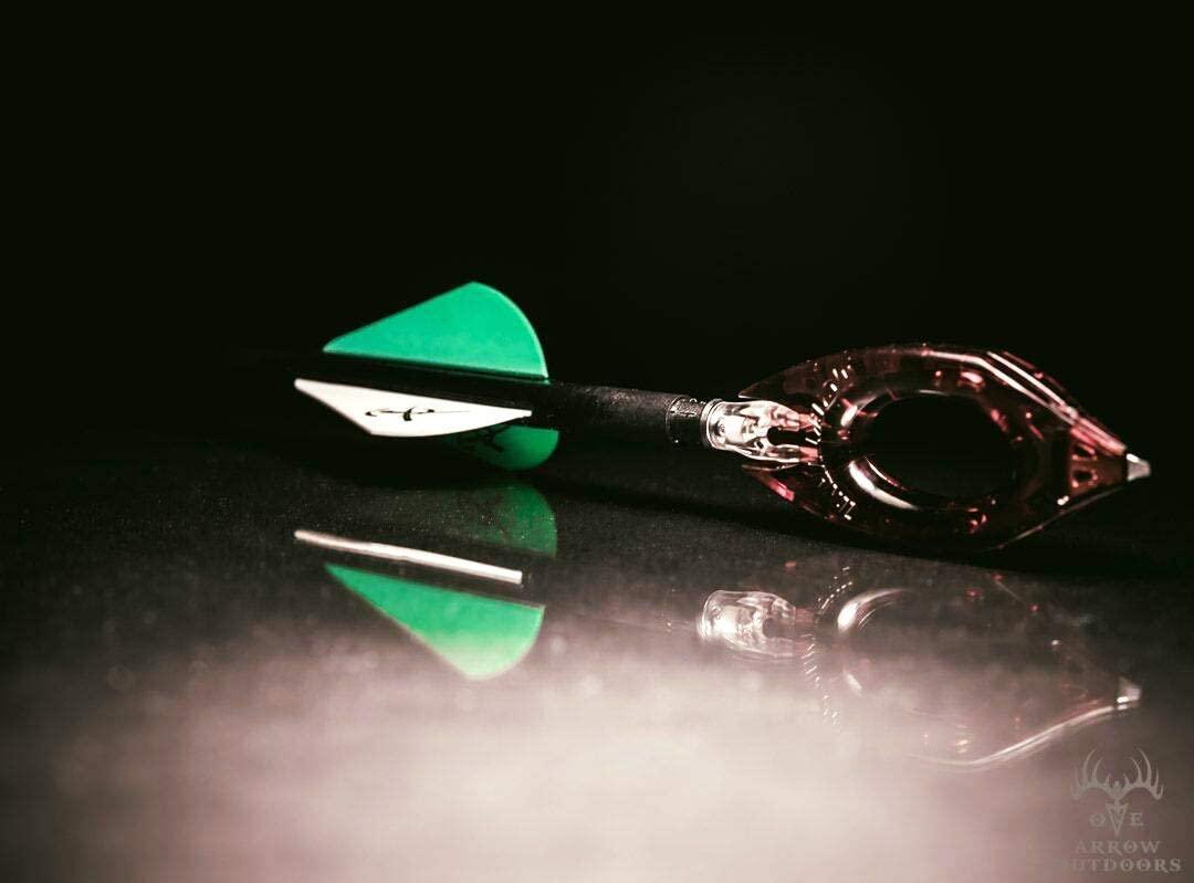 Nockturnal archery universal nock tool with arrow, green and white vanes, black background