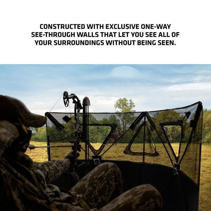 Hunter in camouflage with a bow inside a Primos SurroundView stakeout hunting blind outdoors