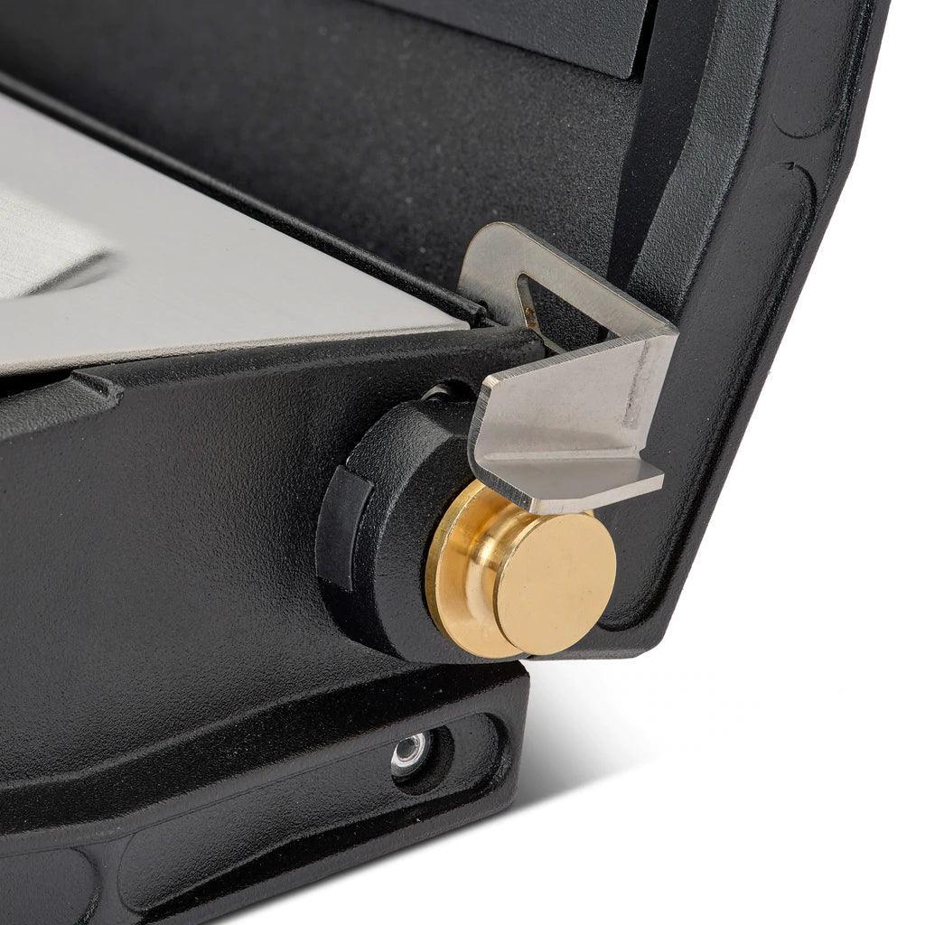 Close-up of Primus Alika stove corner, brass control knob and black metal frame