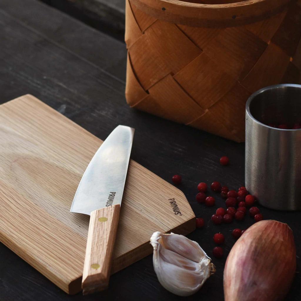 Primus campfire cutting set with wooden cutting board, knife, garlic, shallot, and berries