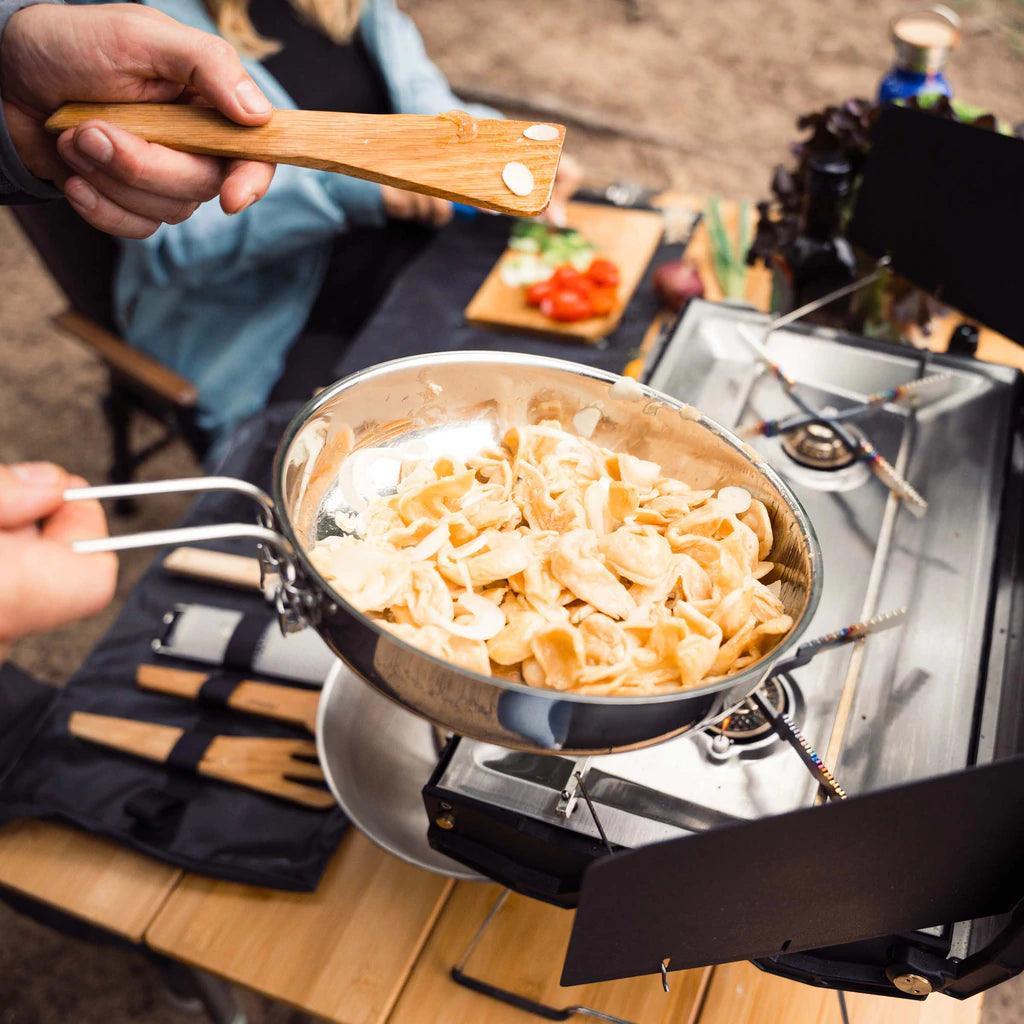 Primus stainless campfire frying pan with pasta on outdoor camping stove