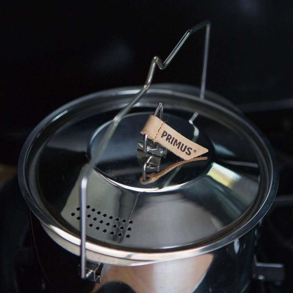 Primus stainless steel campfire pot with lid, handle, and branded leather tag
