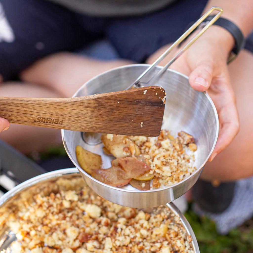 Primus stainless steel campsite bowl with apple crumble dessert outdoors