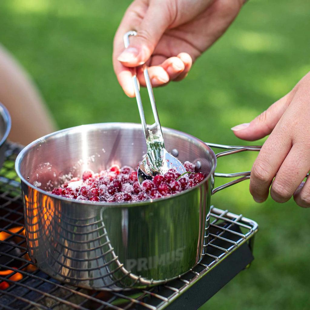 Primus stainless steel campsite cookset with berries on outdoor grill