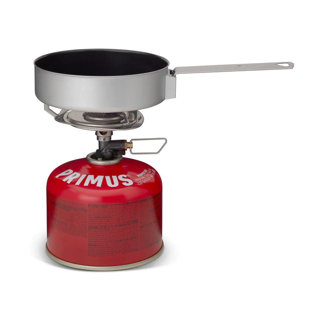 Primus campsite backpacking stove kit with red fuel canister and metal pan on white background