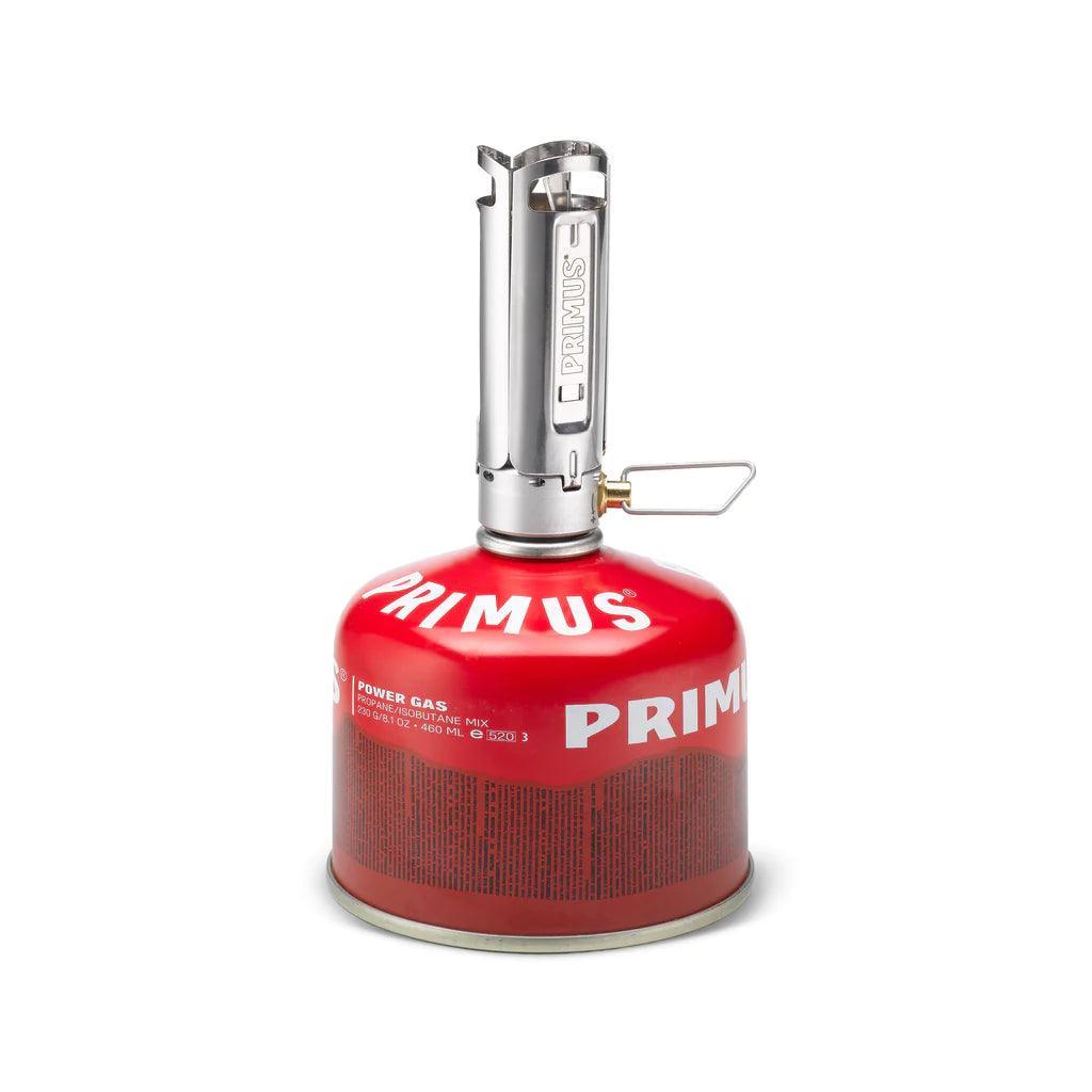 Primus Firestick backpacking stove with red fuel canister on white background