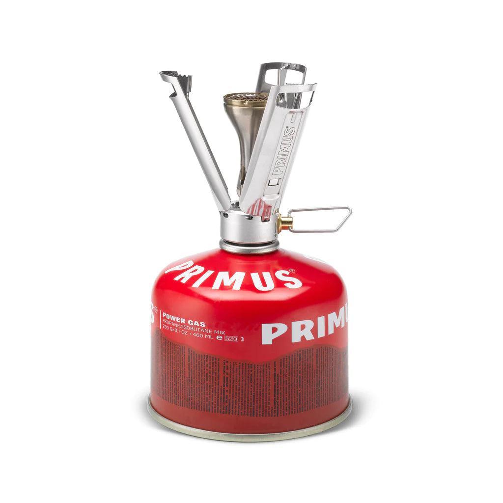 Primus Firestick backpacking stove with red gas canister on a white background