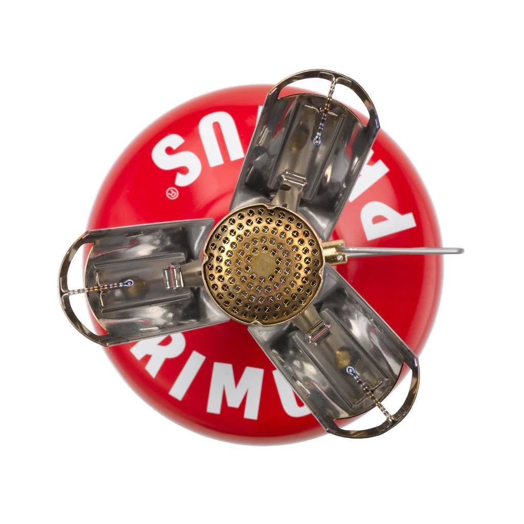 Primus Firestick backpacking stove on red fuel canister, top-down view