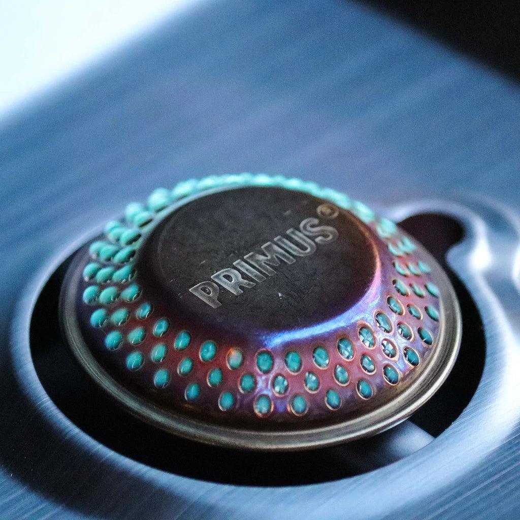 Close-up of Primus Kinjia camping stove burner head on stainless steel surface
