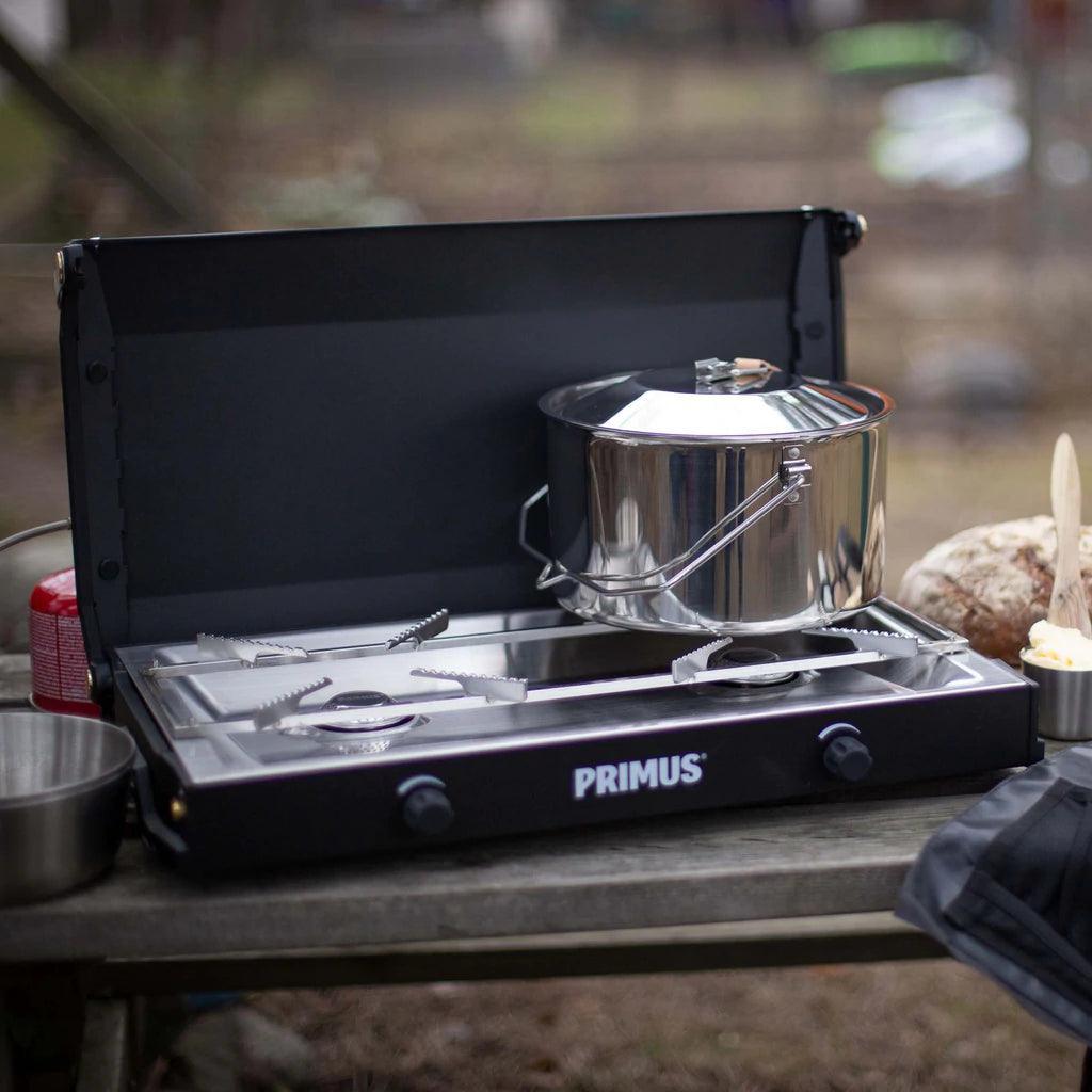 Primus Kinjia camping stove with pot on outdoor picnic table, portable gas burner
