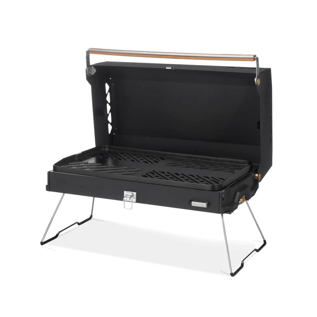 Primus Kuchoma portable gas camp grill with open lid and foldable legs on white background
