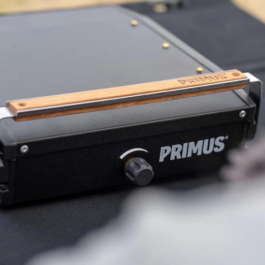 Primus Moja single burner camp stove with wood handle and control knob on black surface