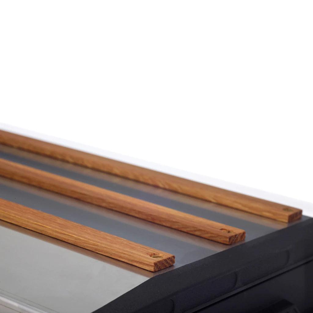 Close-up of Primus Tupike stove with sleek metal surface and wooden accents