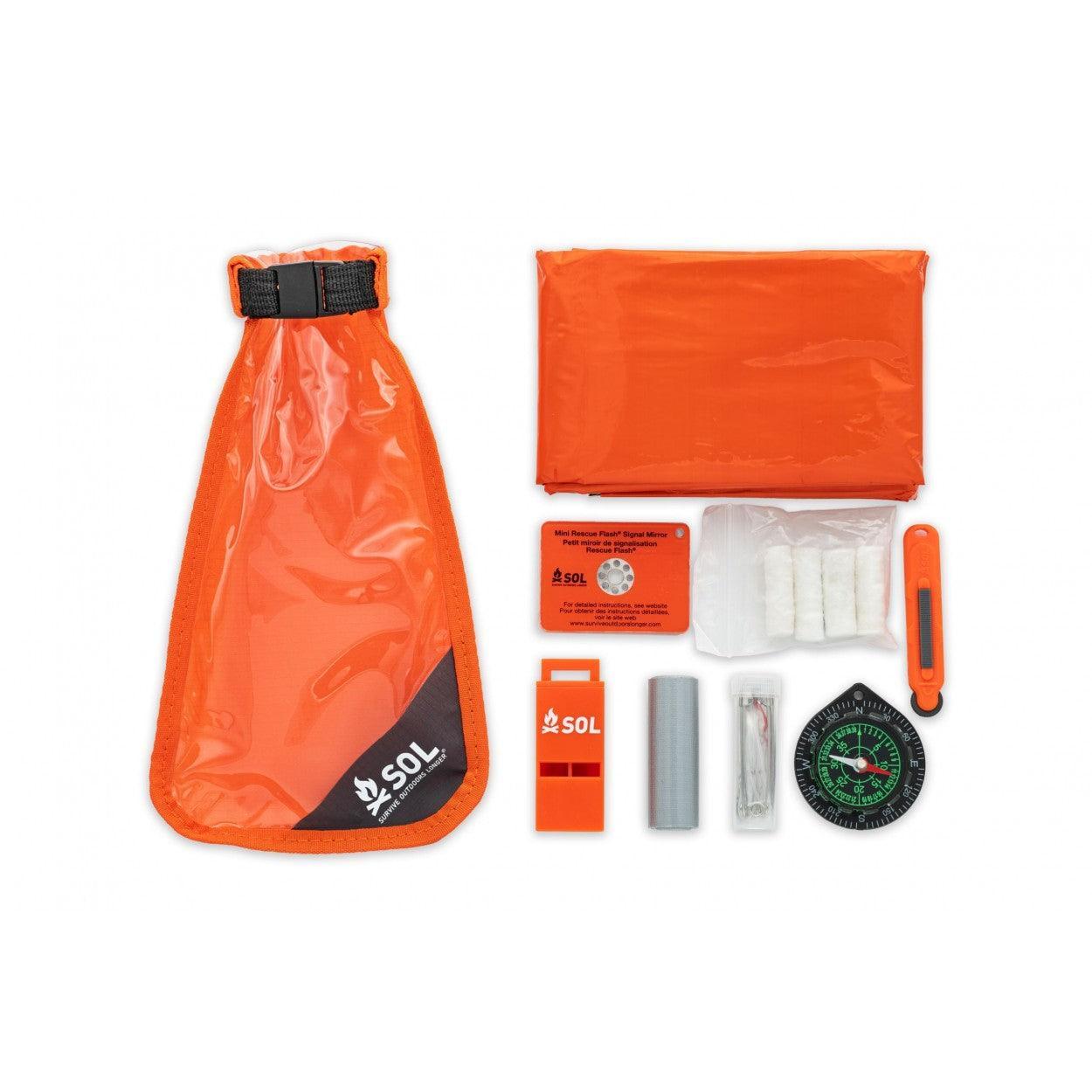 SOL Scout survival kit with orange dry bag, emergency blanket, compass, whistle, and safety tools.