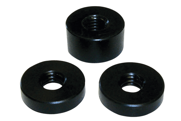 Three black Delrin archery scope spacers on a plain background