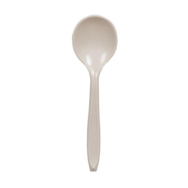 Beige plastic camping spoon on a white background, Stansport outdoor cutlery.
