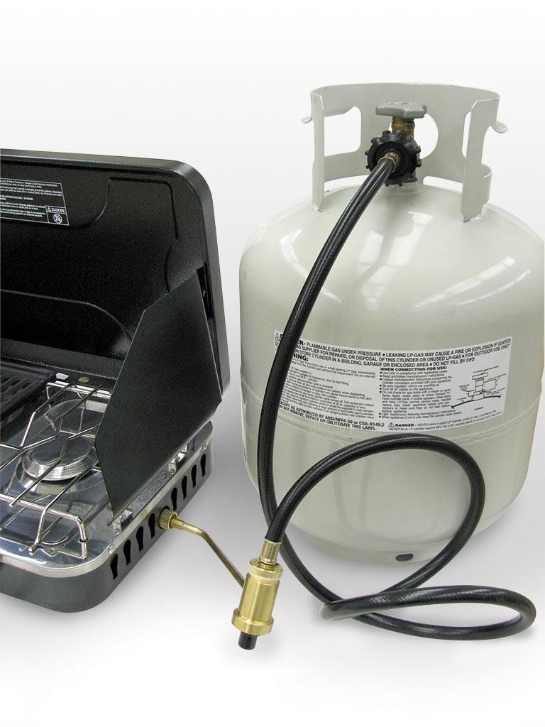 Propane hose connecting portable camp stove to bulk tank, camping gas appliance adapter