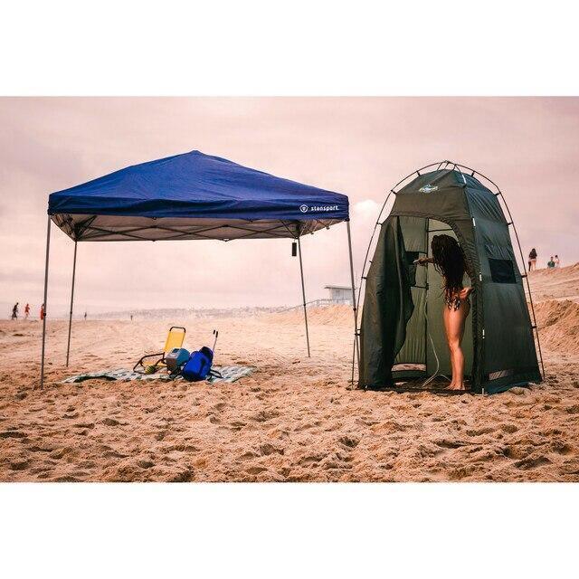 Stansport portable shower tent and canopy set up on sandy beach