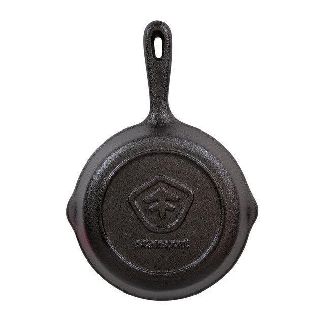 Stansport pre-seasoned cast iron skillet with logo, viewed from the bottom on white background