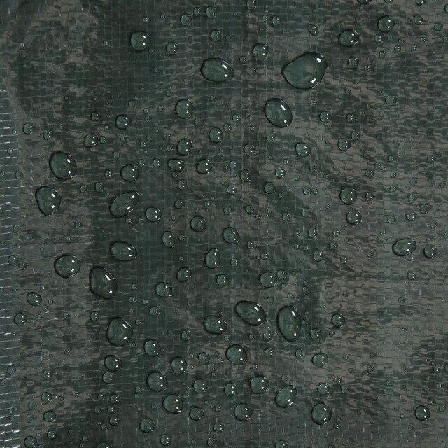 Water droplets on green rip-stop tarp fabric waterproof outdoor material