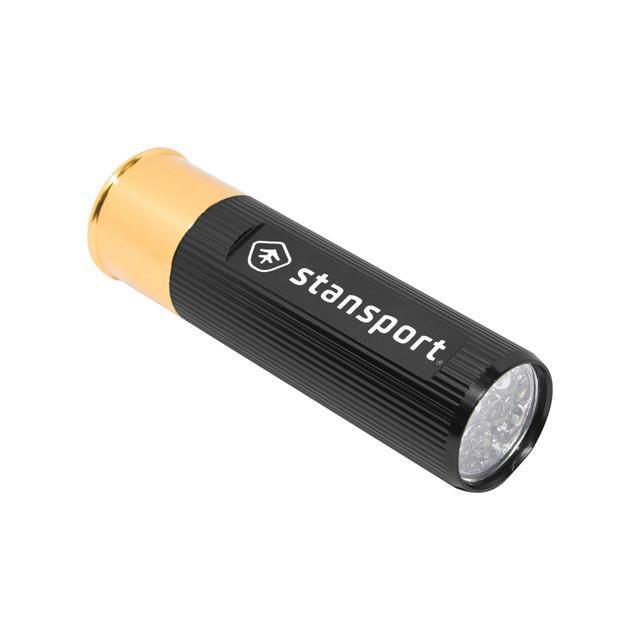 Stansport shotshell LED flashlight with black ribbed body and gold end on white background