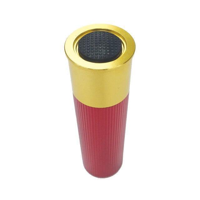 Red and gold shotshell LED flashlight with textured black button on white background