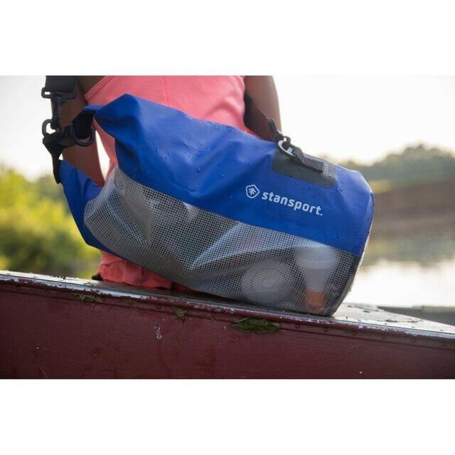 Blue Stansport 10 liter waterproof dry bag outdoors on a boat near water