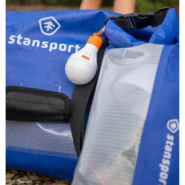 Blue Stansport waterproof dry bags with transparent panel and gear, outdoor setting