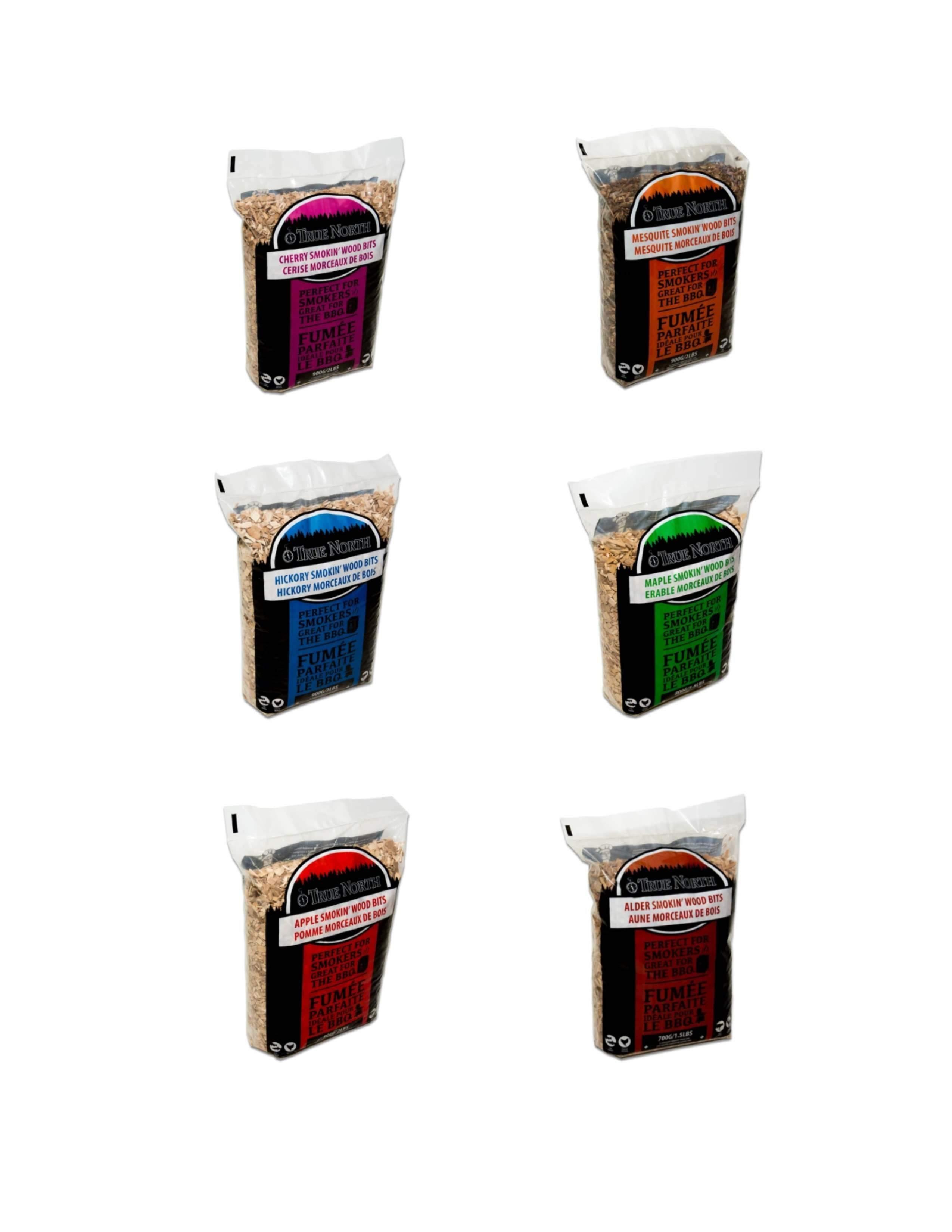 Six bags of True North Smokin' Wood Bits in assorted flavors for BBQ smoking.